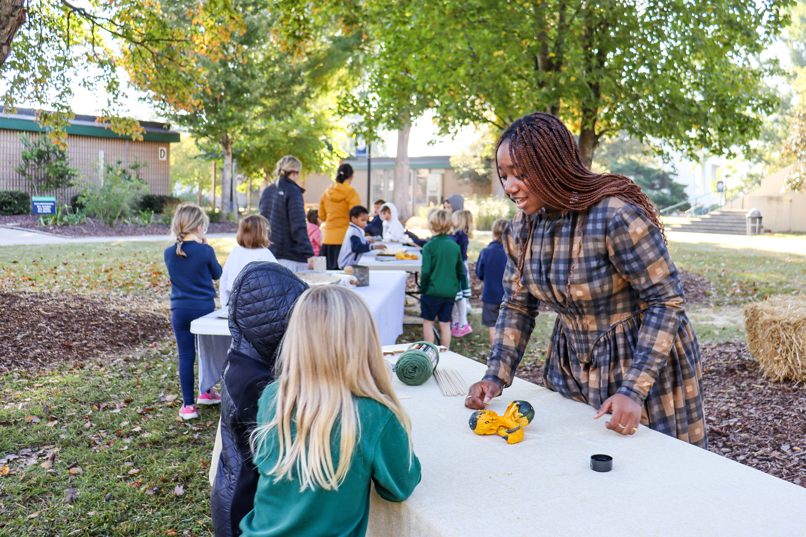 Upper-school student, Yana Johnson, instructs students in period dress