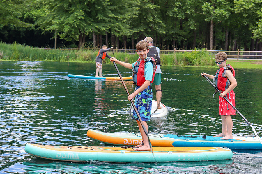 Paddle Boarding on Heathwood's Pond during Summer Programs